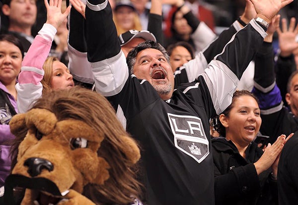 A man cheers at a Kings game inside STAPLES Center.