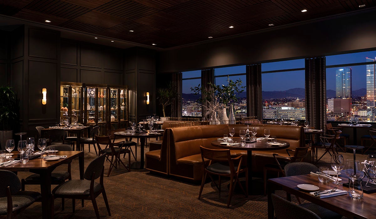 The dining room at night with views of the L.A. skyline at Leña at Sendero.