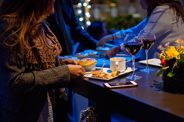 A woman eating an at L.A. LIVE event.