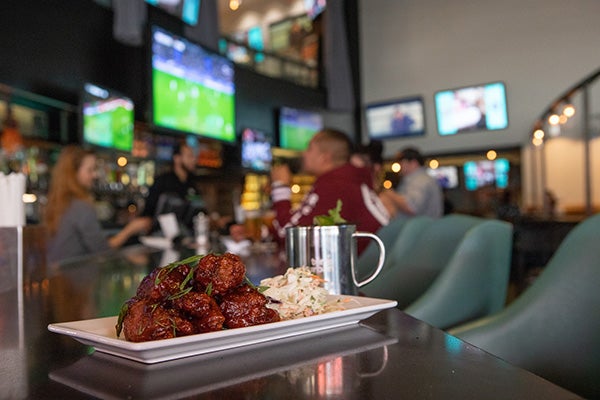 A plate of hot wings on a table in Tom’s Watch Bar.