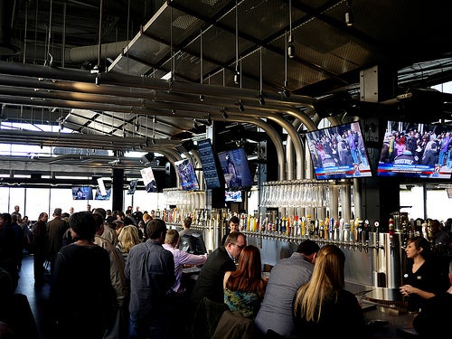 Patrons seated at Yard House's bar.